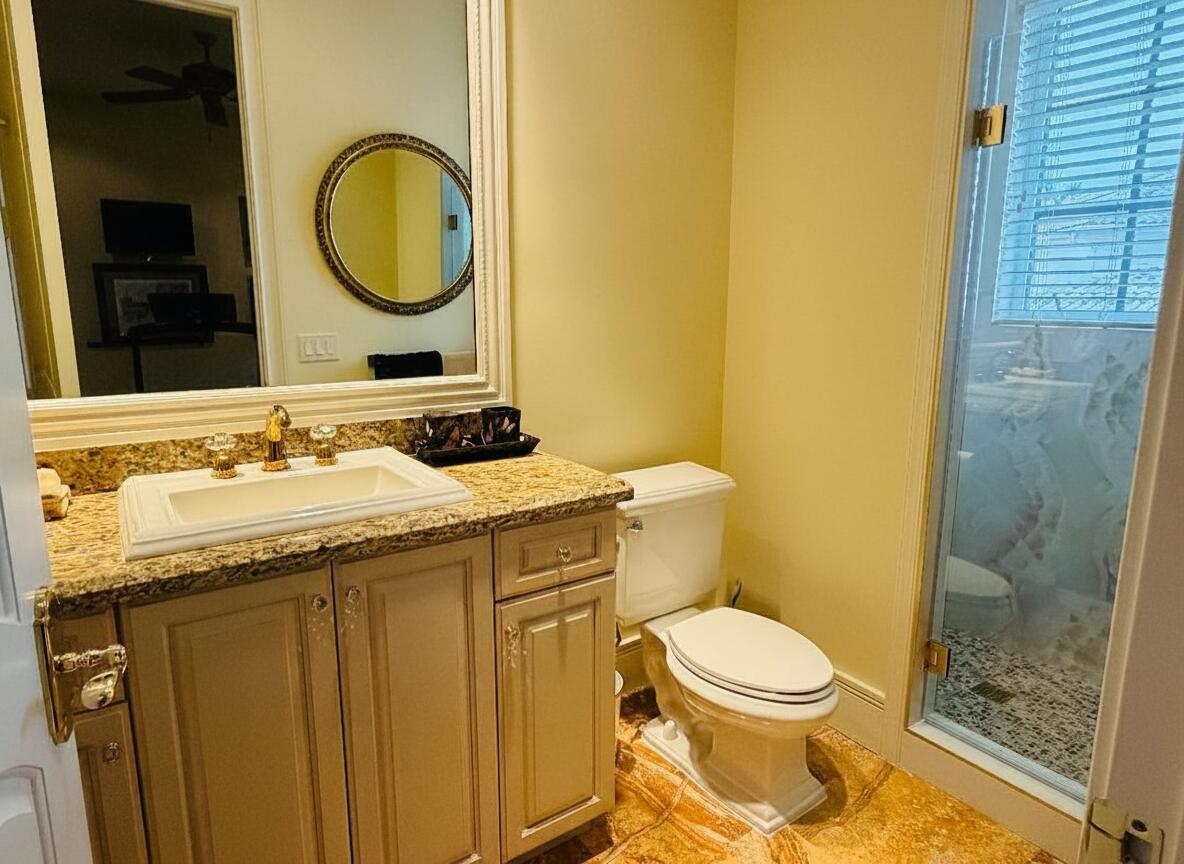 17730 Scarsdale Way Boca Raton, FL 33496 - Photo 29 of 42 a bathroom with a granite countertop toilet sink and mirror