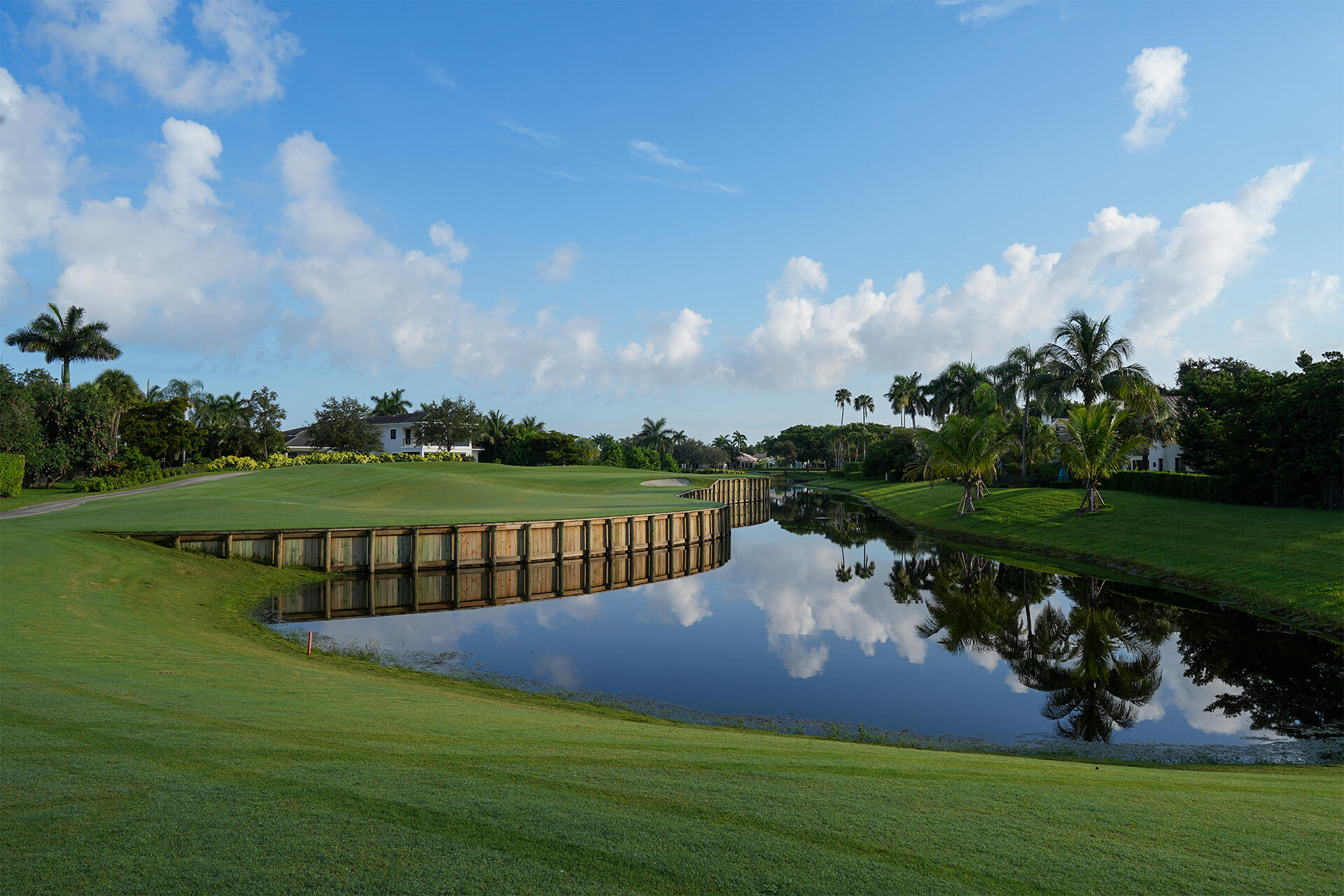 17730 Scarsdale Way Boca Raton, FL 33496 - Photo 37 of 42 a view of a bench in the garden near a lake