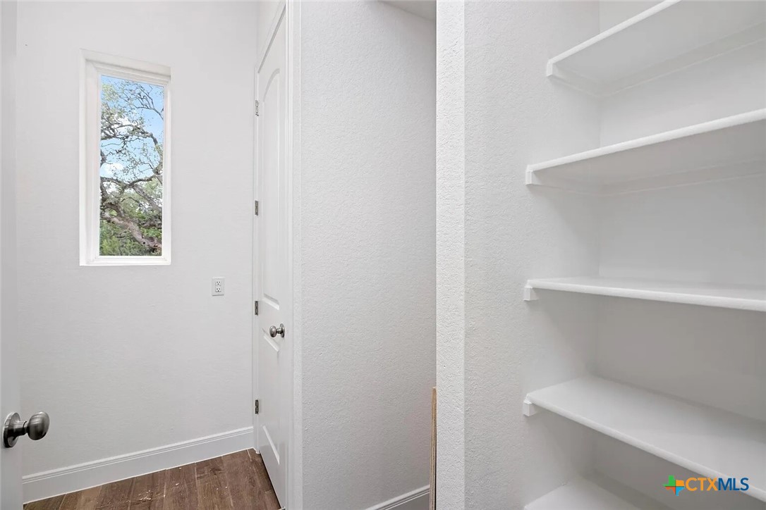155 North Rip Ford Road, Unit B Spring Branch, TX 78070 - Photo 14 of 17 a view of room with window and wooden floor