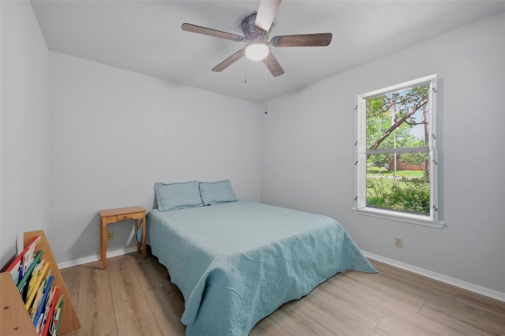 522 High Country Road Sherman, TX 75092 - Photo 19 of 38 a bedroom with a bed and a chandelier