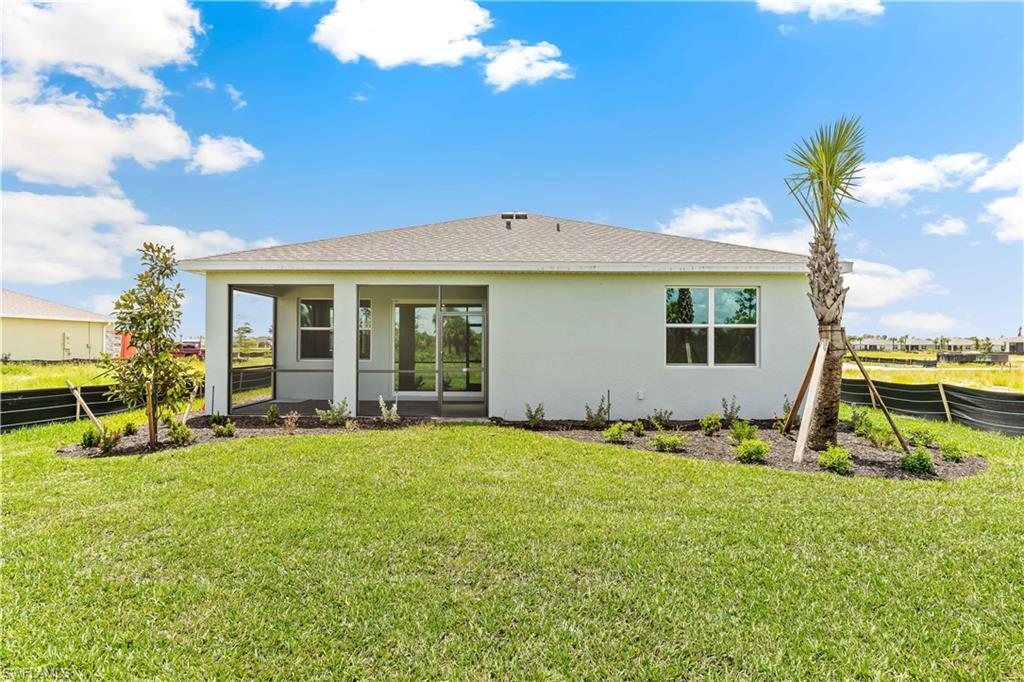 17788 Shade Tree Loop Punta Gorda, FL 33982 - Photo 17 of 44 Back of property featuring roof with shingles, stucco siding, and a sunroom