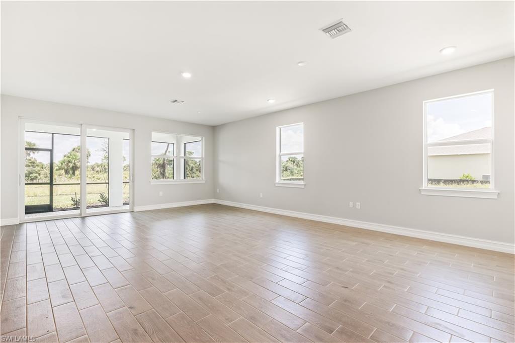 17788 Shade Tree Loop Punta Gorda, FL 33982 - Photo 2 of 44 Unfurnished room with recessed lighting, wood finish floors, and healthy amount of natural light