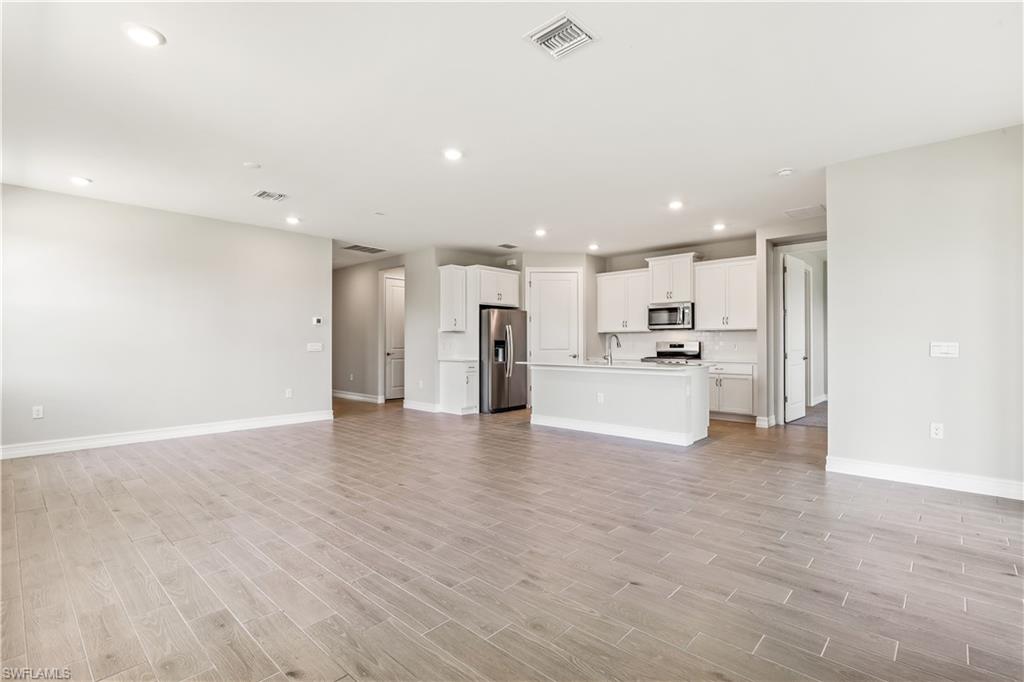 17788 Shade Tree Loop Punta Gorda, FL 33982 - Photo 4 of 44 Unfurnished living room with recessed lighting and light wood-style flooring