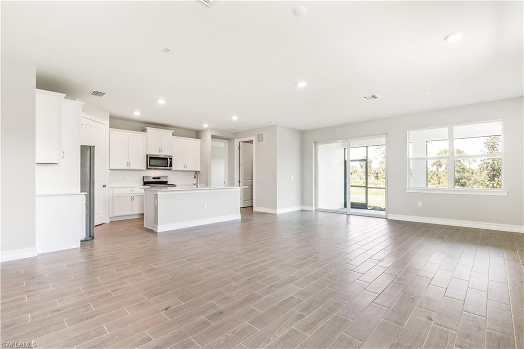 17788 Shade Tree Loop Punta Gorda, FL 33982 - Photo 5 of 44 Unfurnished living room featuring recessed lighting and wood finish floors