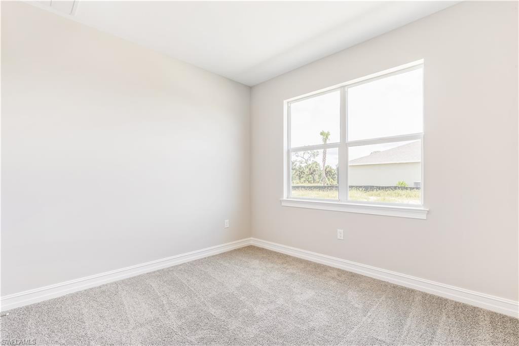 17788 Shade Tree Loop Punta Gorda, FL 33982 - Photo 10 of 44 Carpeted empty room featuring baseboards