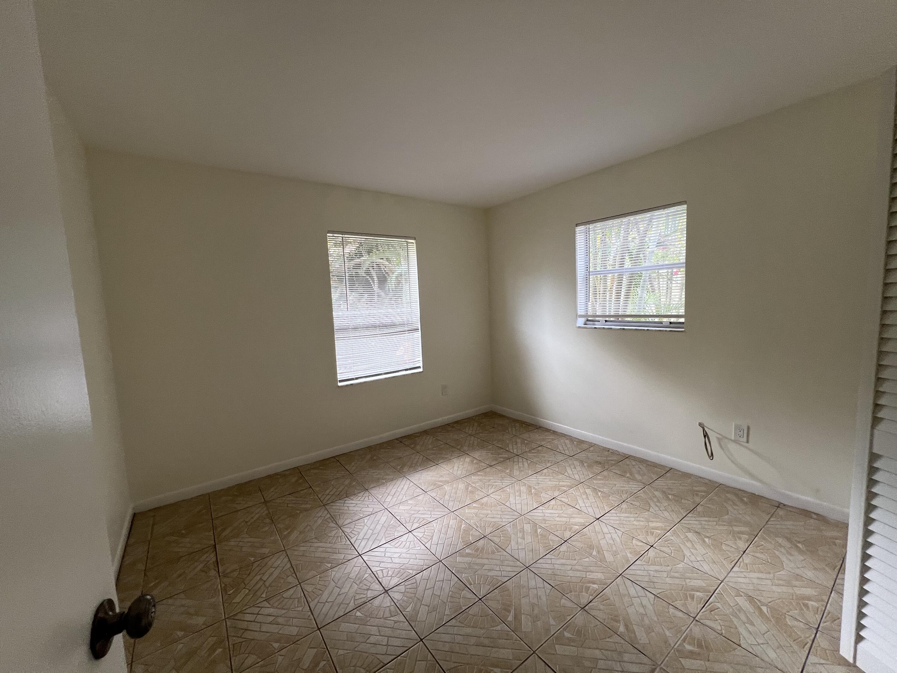 17355 Bush Road, Unit F Jupiter, FL 33458 - Photo 11 of 21 an empty room with windows