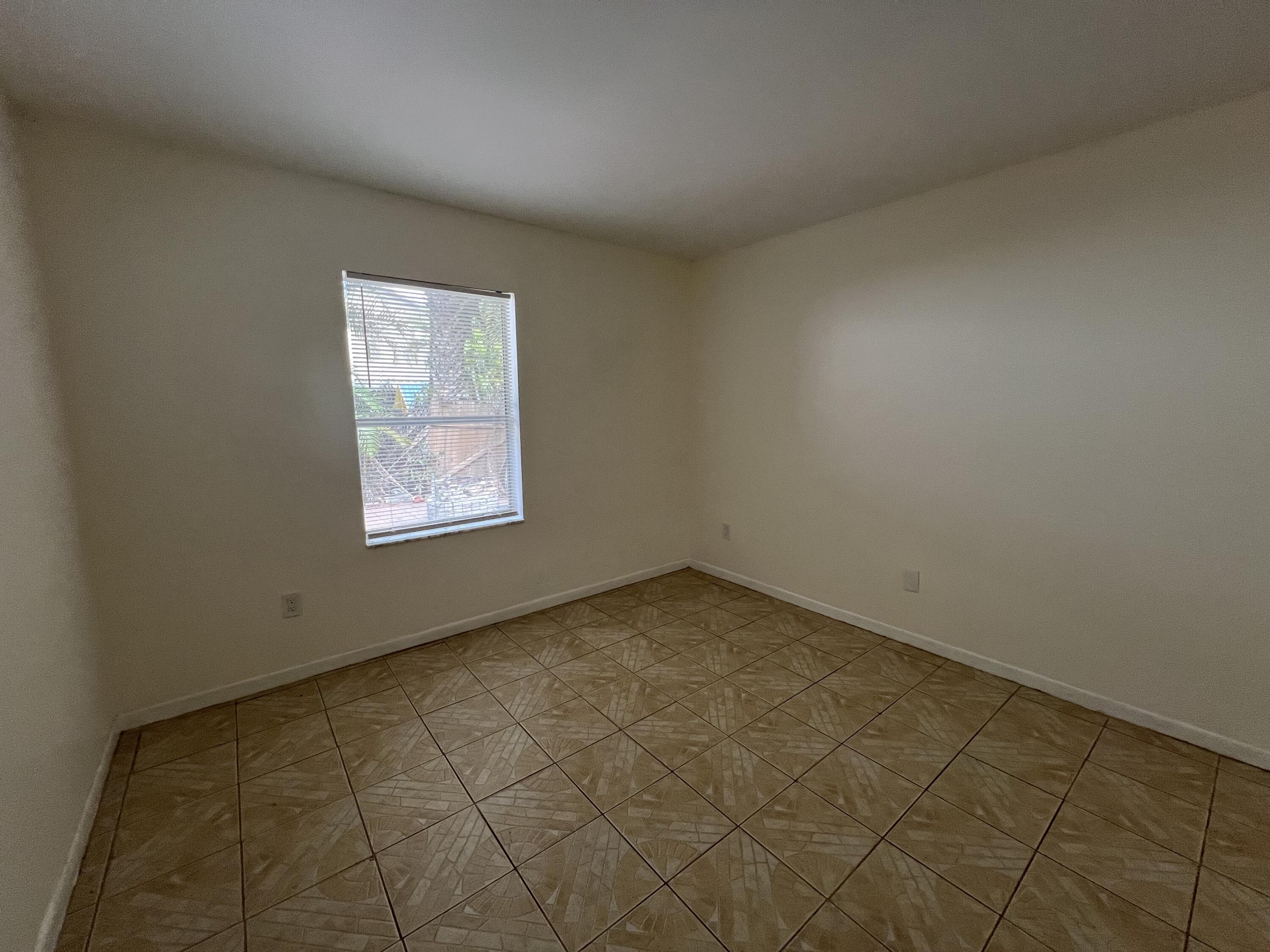17355 Bush Road, Unit F Jupiter, FL 33458 - Photo 16 of 21 an empty room with a window
