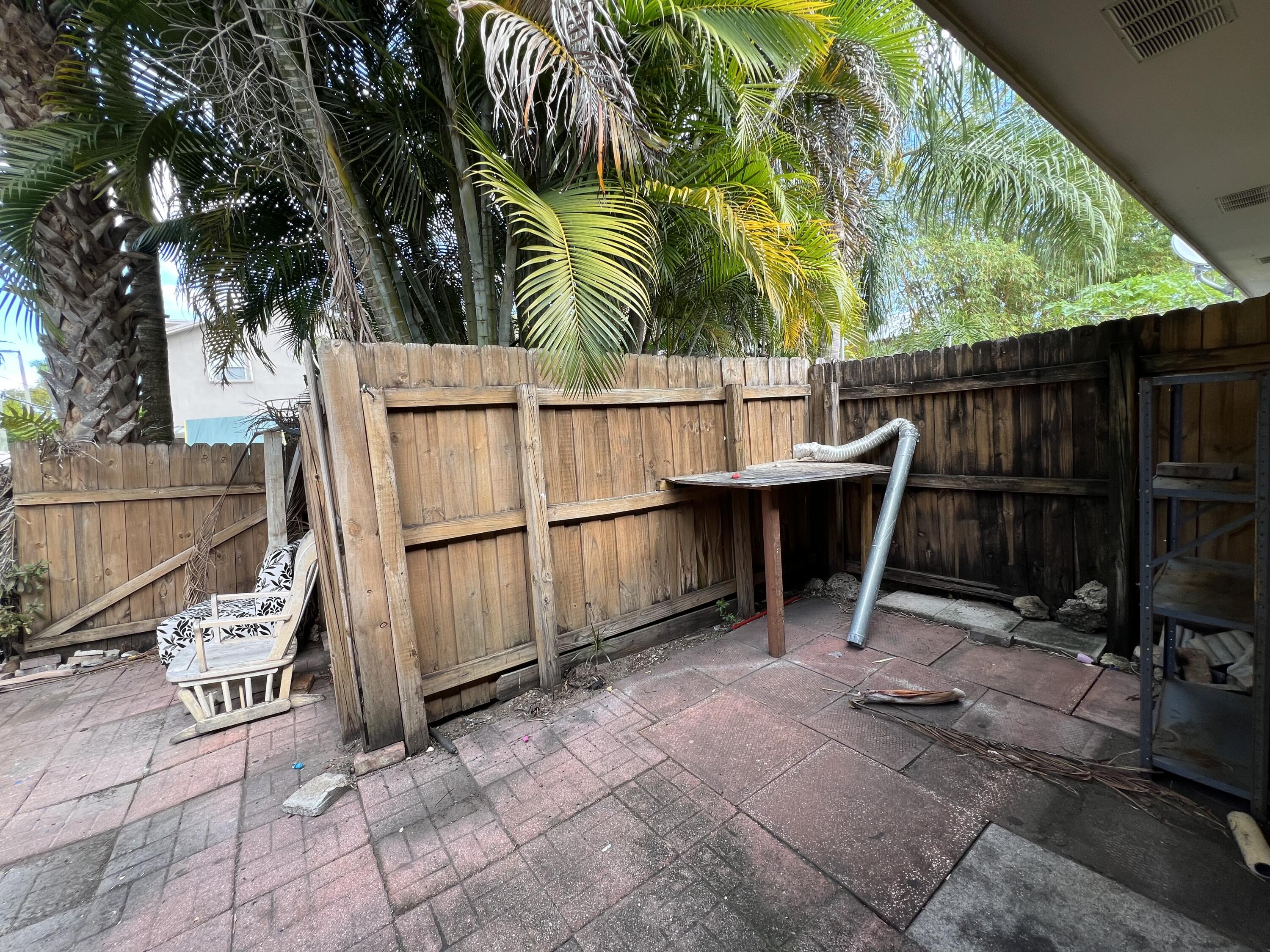 17355 Bush Road, Unit F Jupiter, FL 33458 - Photo 17 of 21 a view of outdoor space with seating area and trees