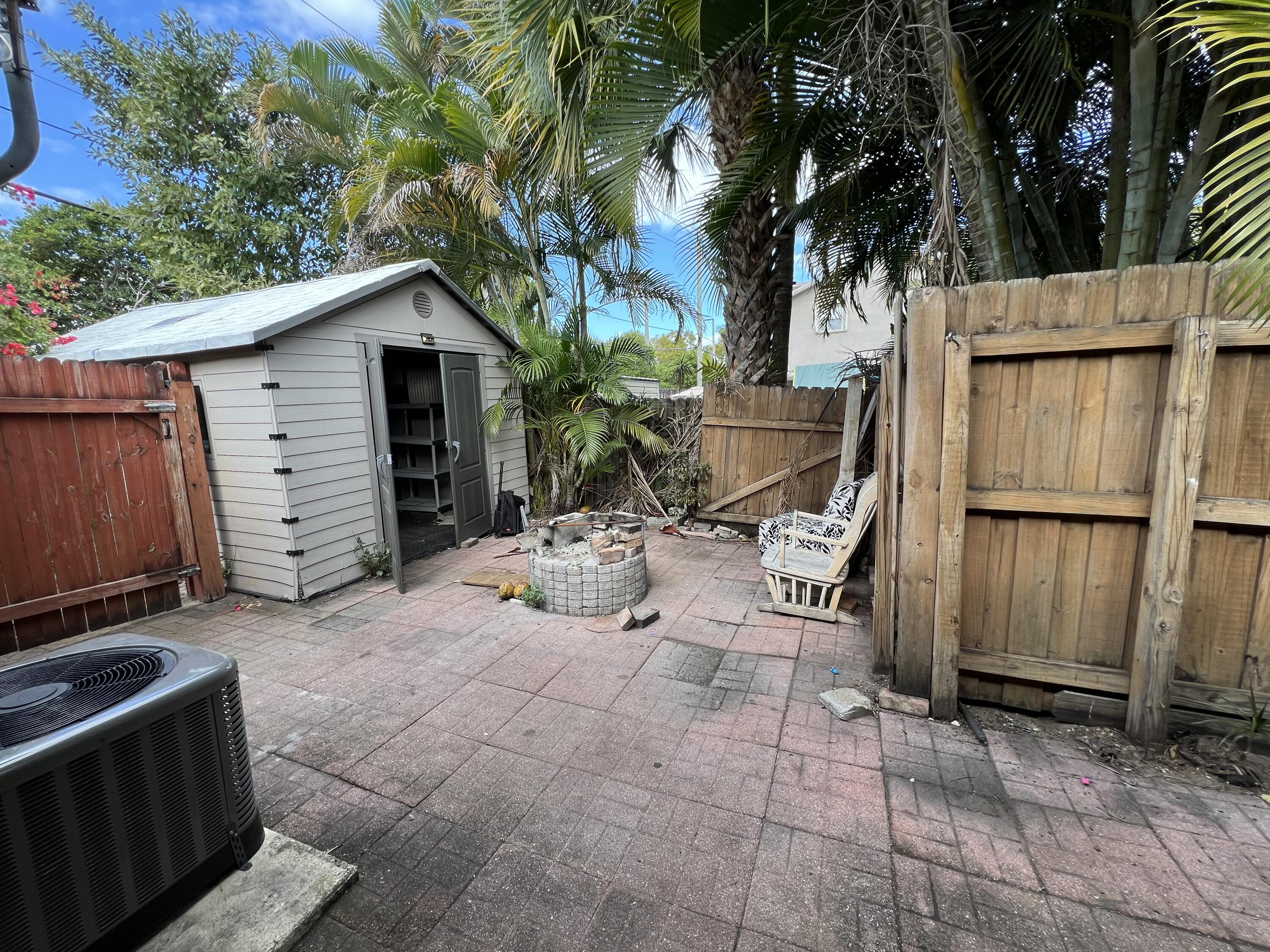 17355 Bush Road, Unit F Jupiter, FL 33458 - Photo 18 of 21 a view of a house with backyard and sitting area