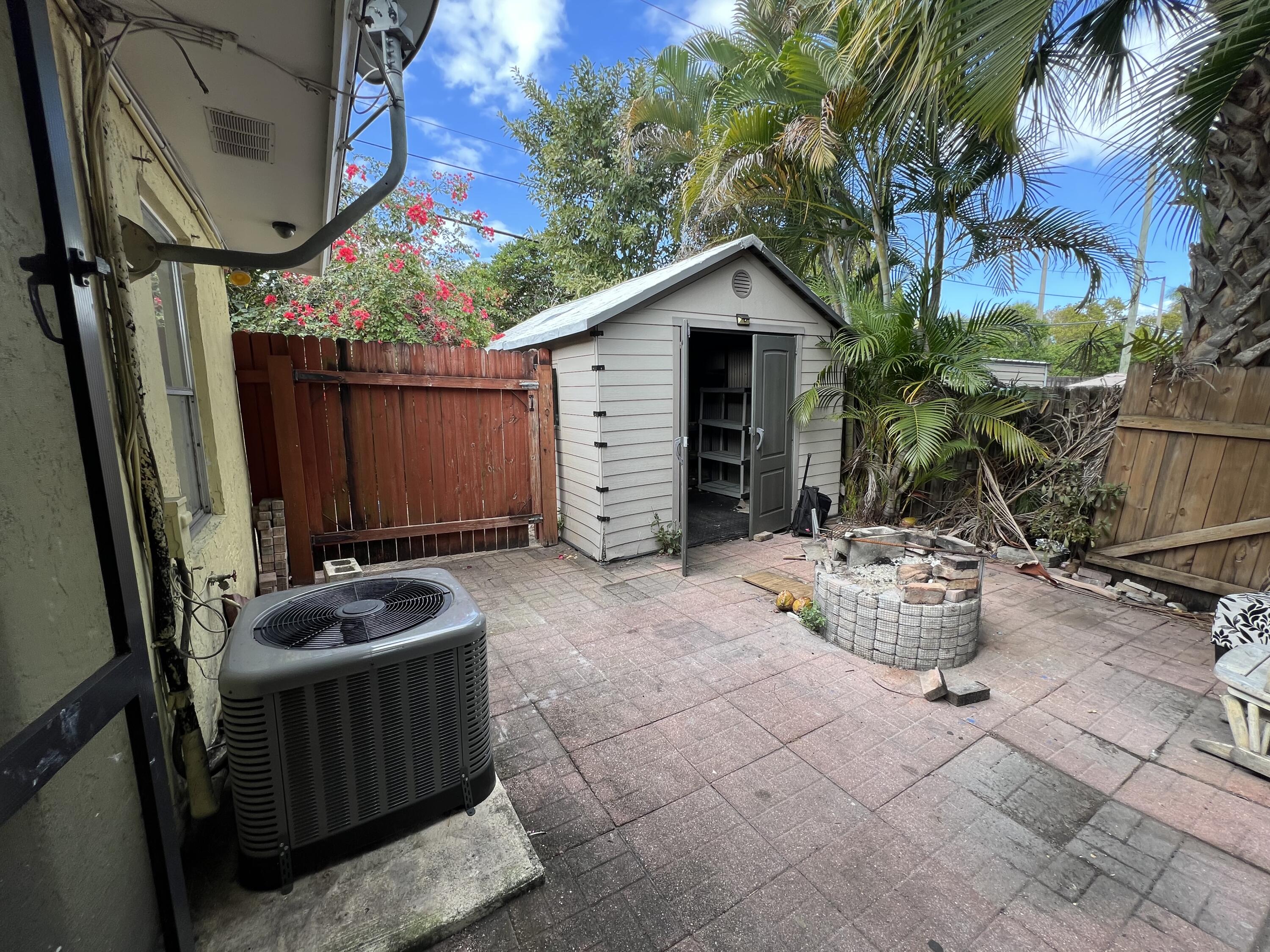 17355 Bush Road, Unit F Jupiter, FL 33458 - Photo 19 of 21 a view of backyard with outdoor seating and plants