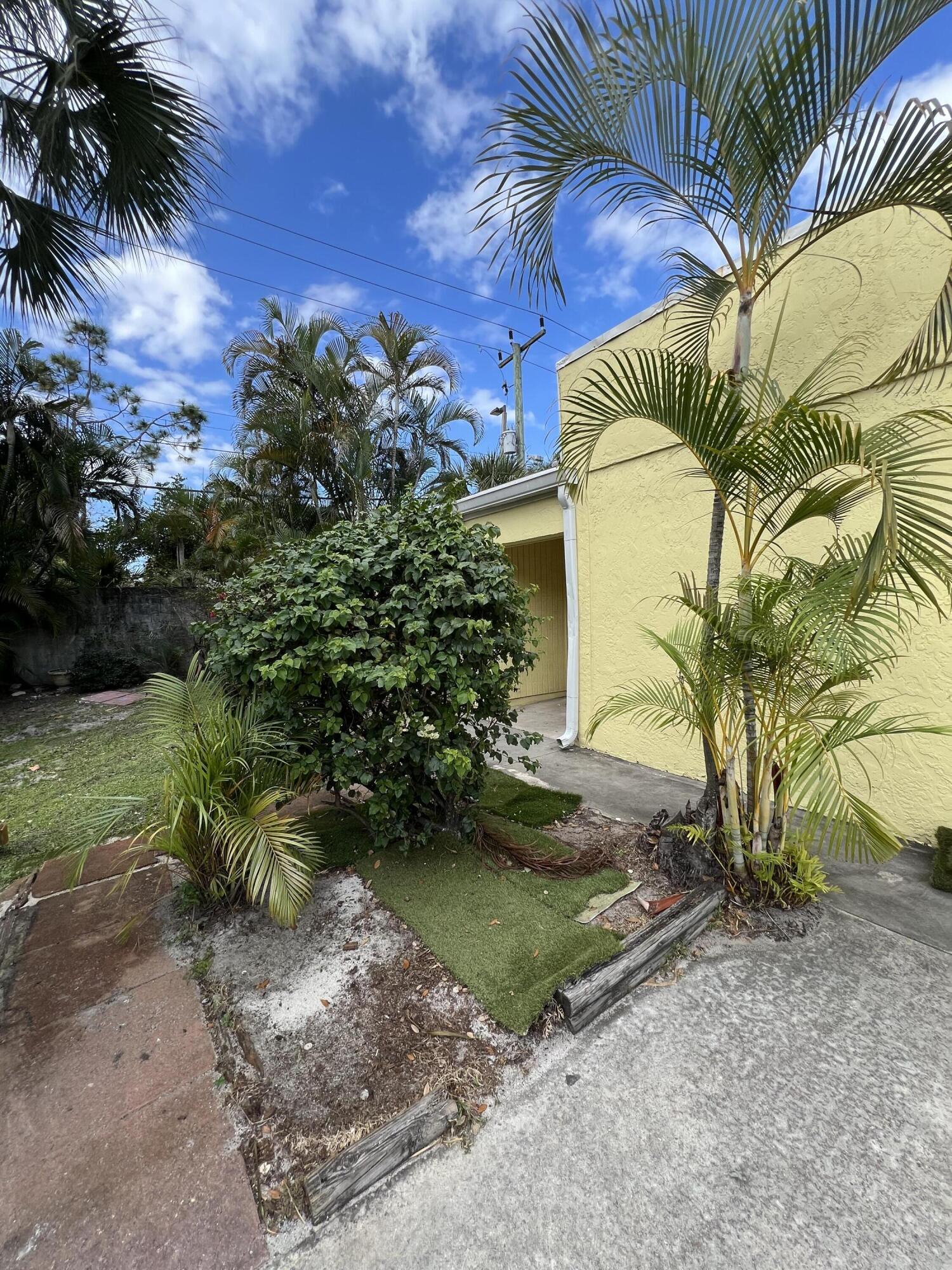 17355 Bush Road, Unit F Jupiter, FL 33458 - Photo 2 of 21 a view of a yard with plants