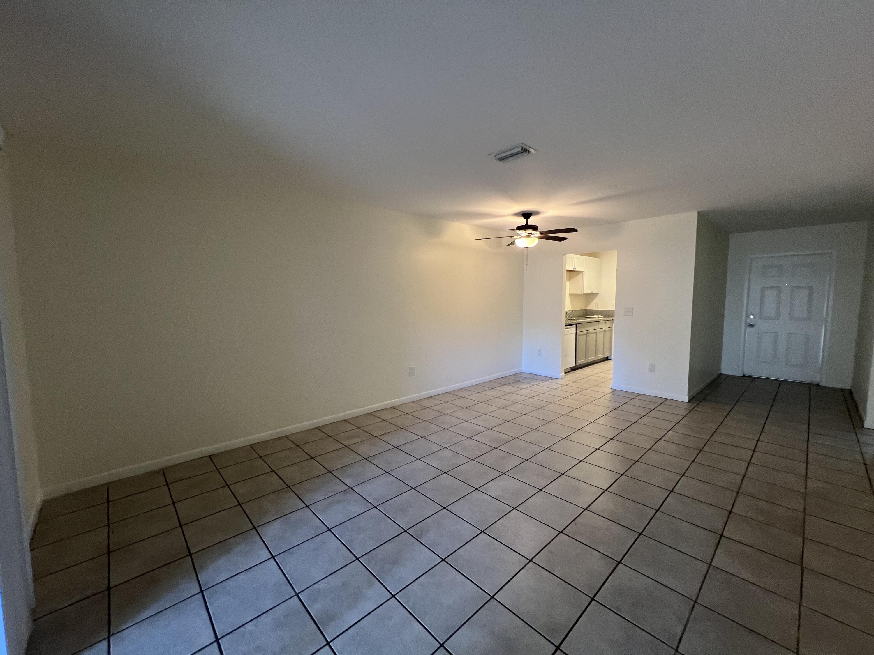 17355 Bush Road, Unit F Jupiter, FL 33458 - Photo 9 of 21 a view of an empty room and chandelier fan