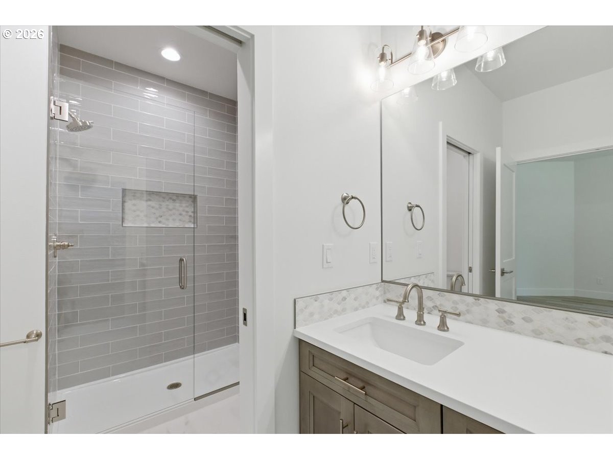 2147 Northeast Spitz Road Canby, OR 97013 - Photo 26 of 48 a bathroom with a shower sink and mirror