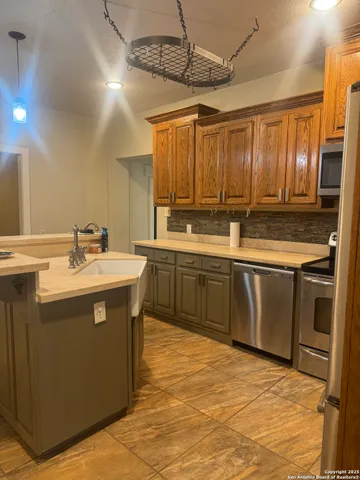 a kitchen with a sink stove and cabinets