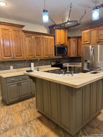 a kitchen with a sink stove and cabinets