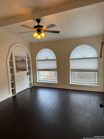 a view of room with window and wooden floor