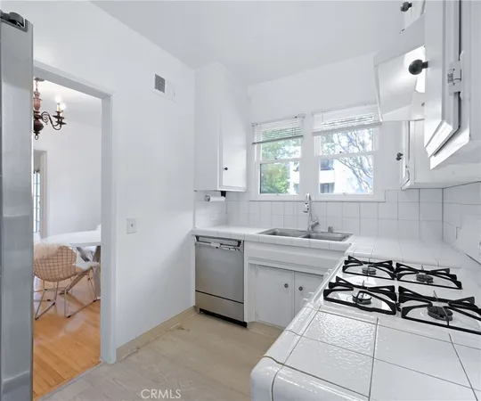 a kitchen with a sink appliances and cabinets