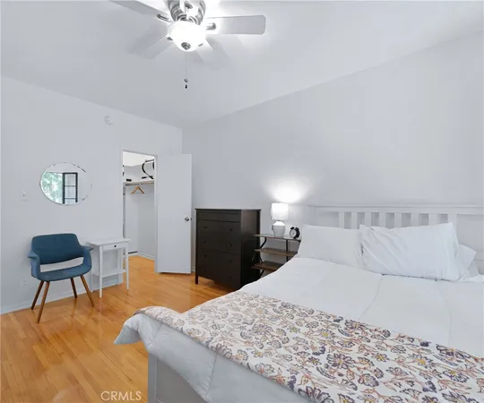 a bedroom with a bed and a chair