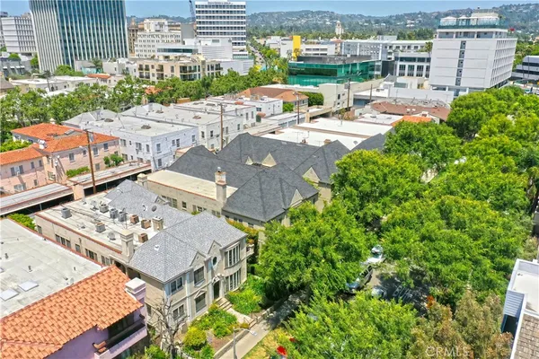 an aerial view of a residential apartment building with a yard and lake view