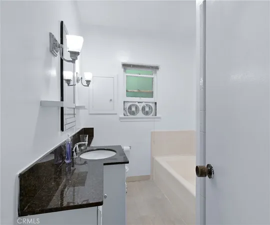 a bathroom with a sink a mirror and shower