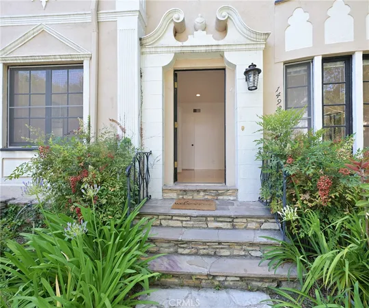 a front view of a house with a garden