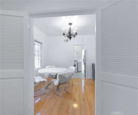 a view of a dining room with furniture and a chandelier
