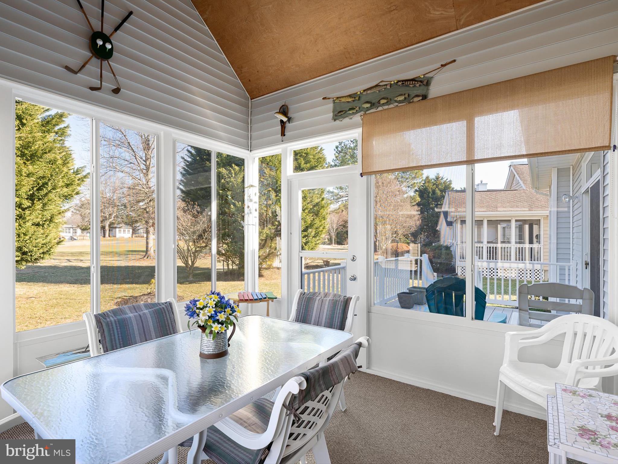 304 Walkabout Road Bethany Beach, DE 19930 - Photo 20 of 62 a view of a dining room with furniture large windows and wooden floor