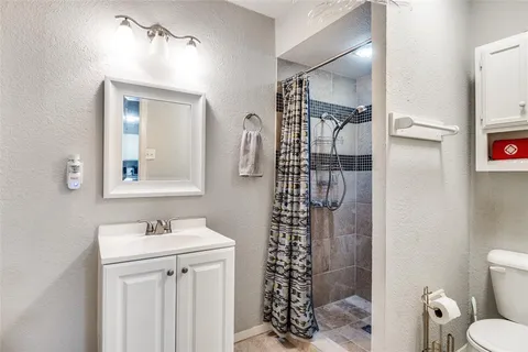 a bathroom with a shower toilet and sink