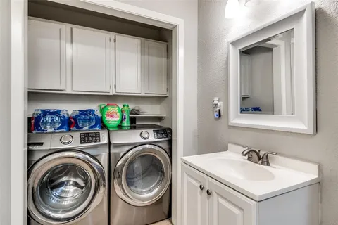 a utility room with sink dryer and washer