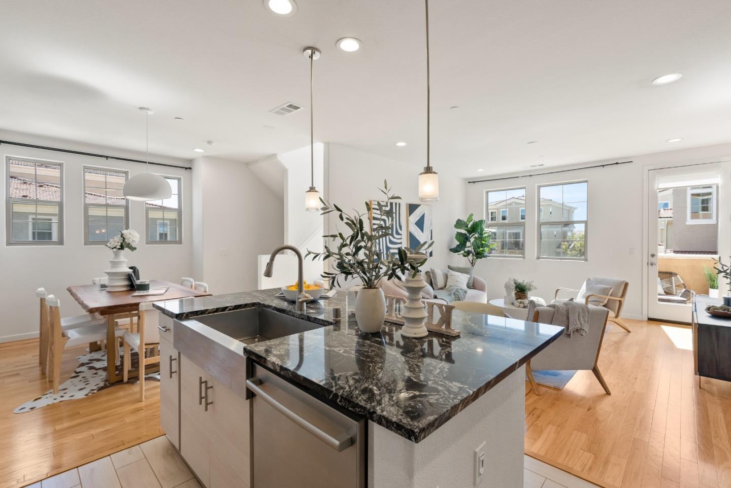1872 Trento Loop Milpitas, CA 95035 - Photo 11 of 38 a kitchen with stainless steel appliances granite countertop a sink a counter space and living room view