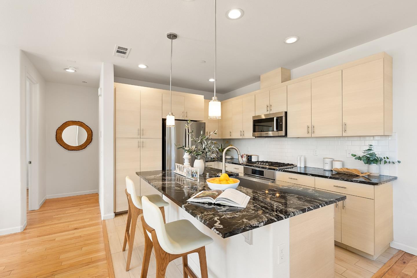 1872 Trento Loop Milpitas, CA 95035 - Photo 7 of 38 a kitchen with stainless steel appliances granite countertop a stove top oven a refrigerator a sink and white cabinets with wooden floors