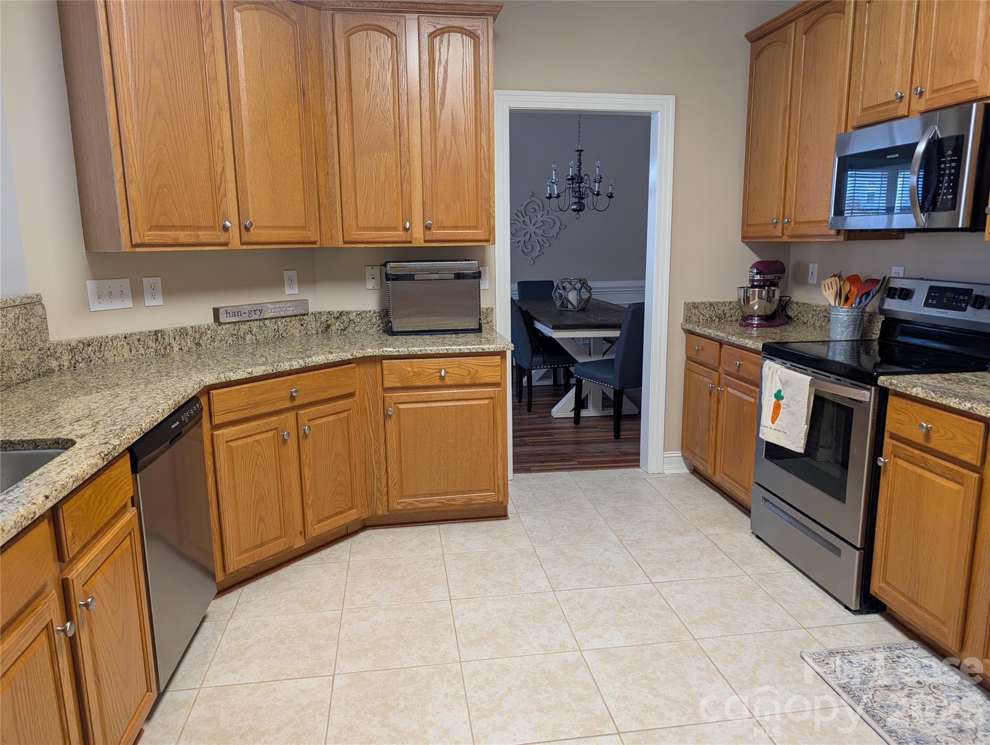 20207 Colony Point Lane Cornelius, NC 28031 - Photo 12 of 26 a kitchen with stainless steel appliances granite countertop a stove sink and cabinets