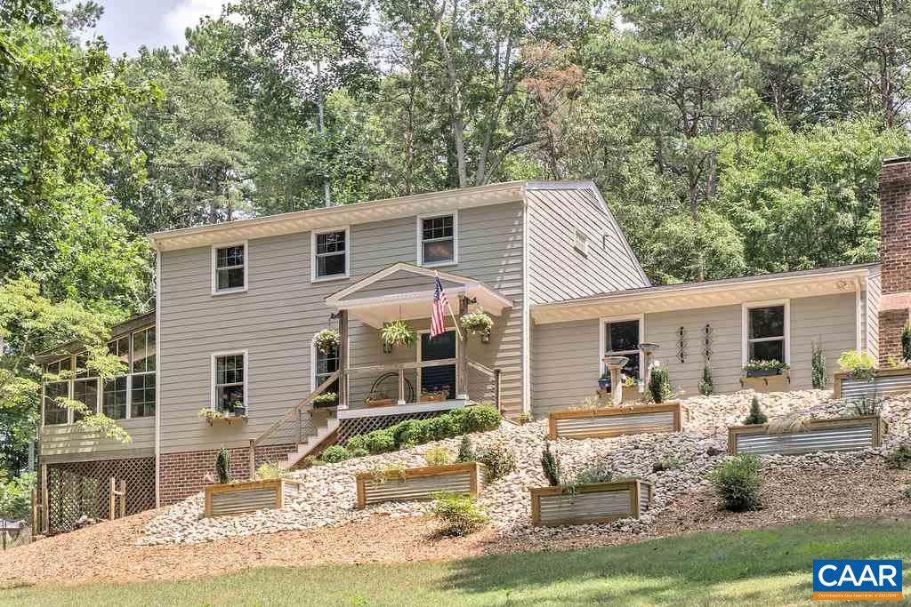 a front view of house with yard outdoor seating and barbeque oven