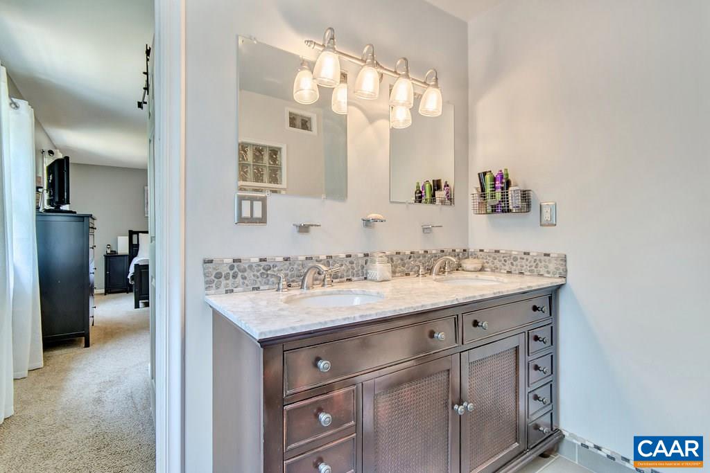 2333 Whippoorwill Road Charlottesville, VA 22901 - Photo 30 of 49 a bathroom with a sink vanity and a mirror