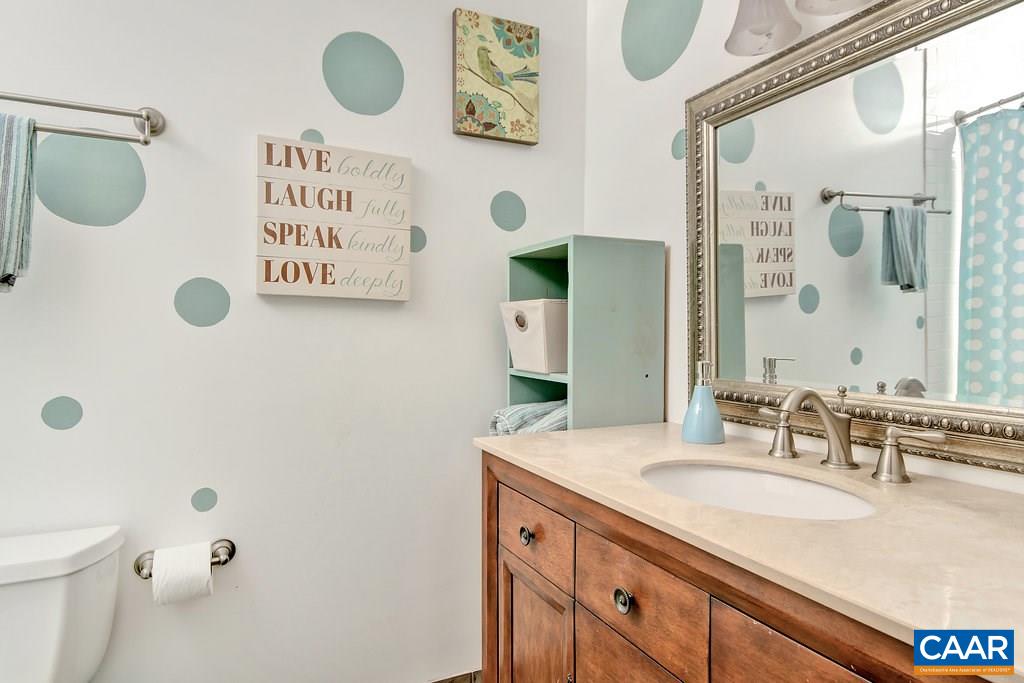 2333 Whippoorwill Road Charlottesville, VA 22901 - Photo 35 of 49 a bathroom with a granite countertop sink a toilet and a mirror