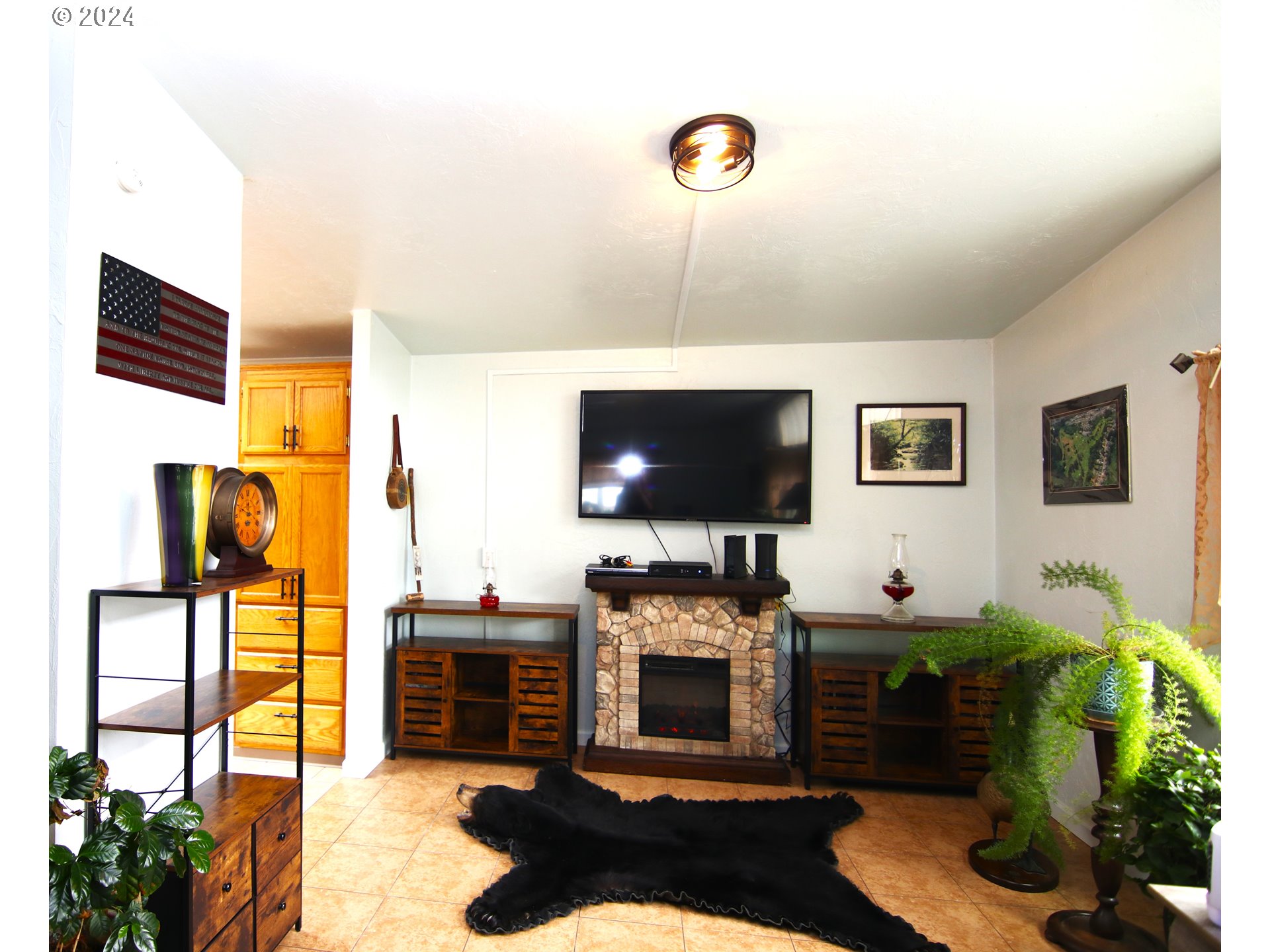 100 River Bend Road, Unit 110 Reedsport, OR 97467 - Photo 4 of 16 a living room with furniture and a flat screen tv