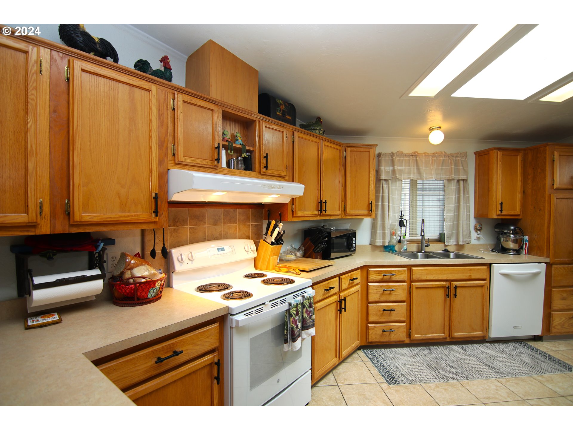 100 River Bend Road, Unit 110 Reedsport, OR 97467 - Photo 6 of 16 a kitchen with kitchen island granite countertop a sink cabinets and stainless steel appliances