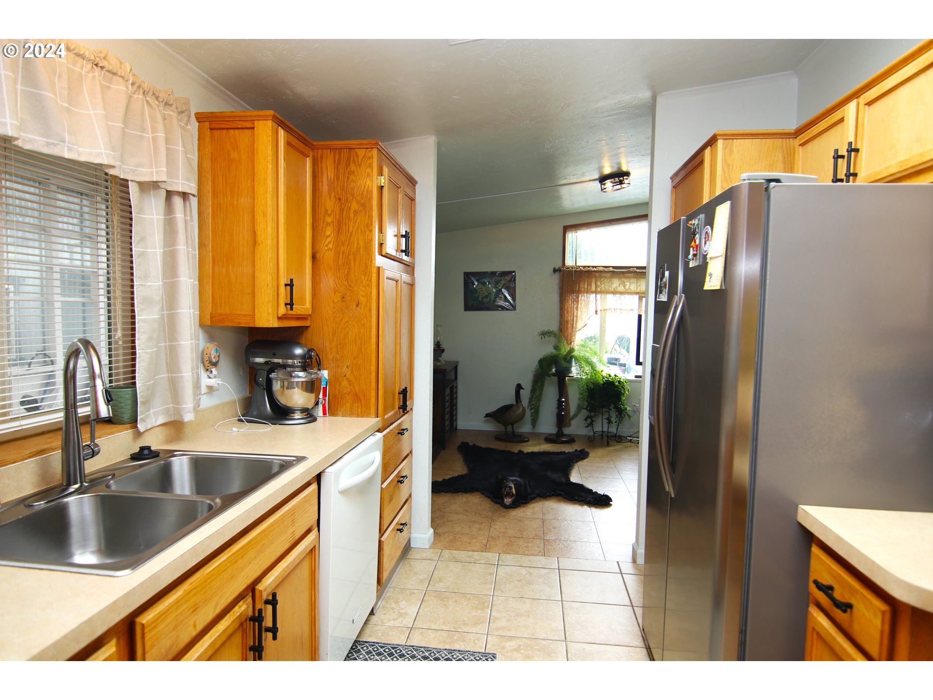 100 River Bend Road, Unit 110 Reedsport, OR 97467 - Photo 7 of 16 a kitchen with stainless steel appliances granite countertop a refrigerator and a sink