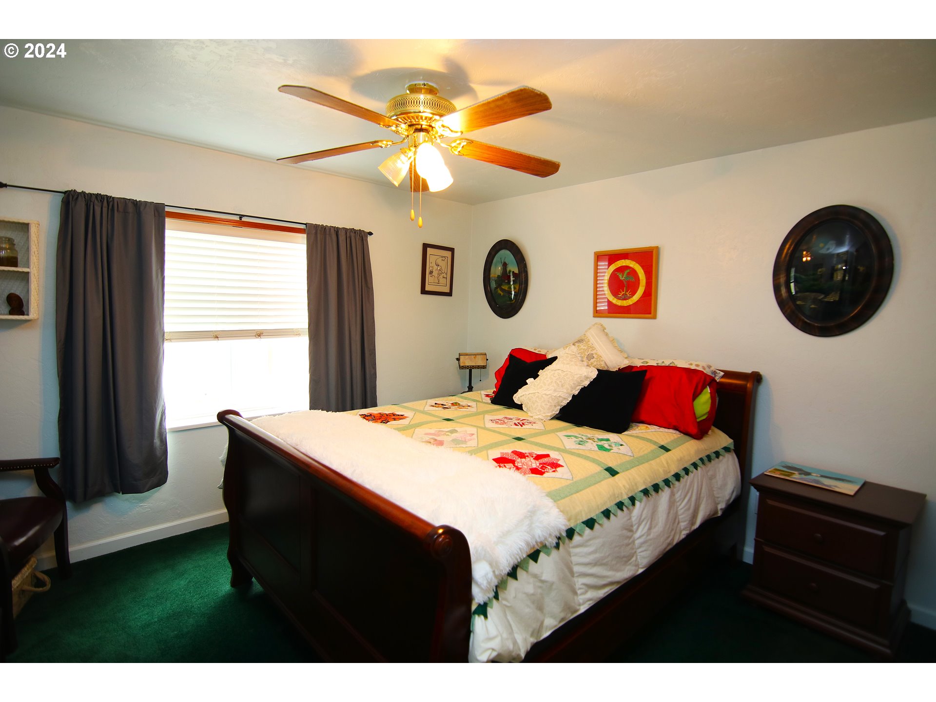 100 River Bend Road, Unit 110 Reedsport, OR 97467 - Photo 9 of 16 a bedroom with a bed and a chandelier