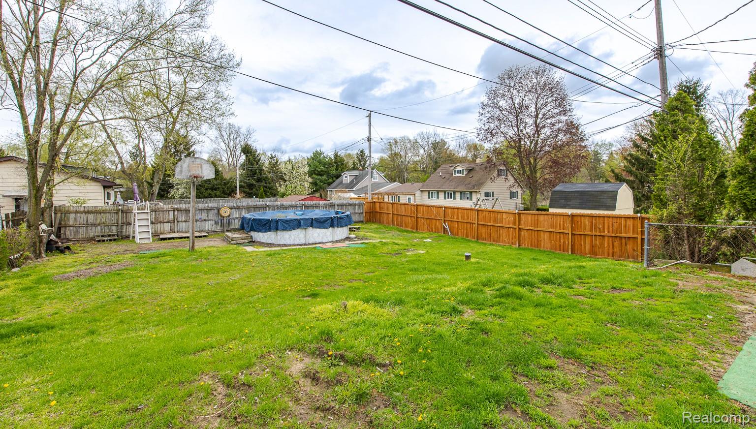 8670 North Eston Road Clarkston, MI 48348 - Photo 22 of 29 Fenced backyard with a residential view