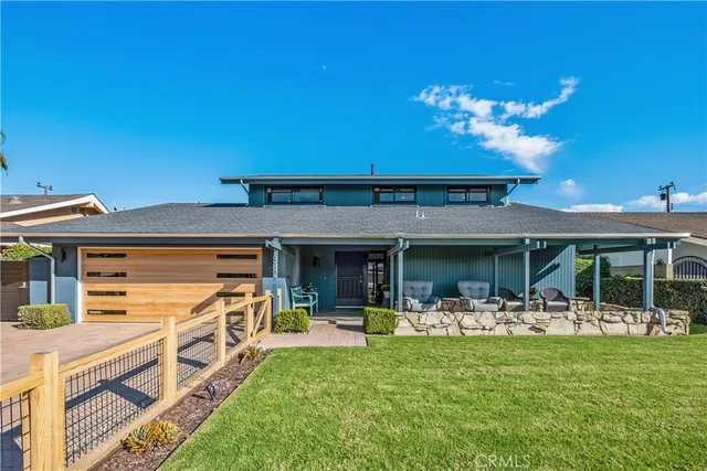 a front view of a house with a garden and patio