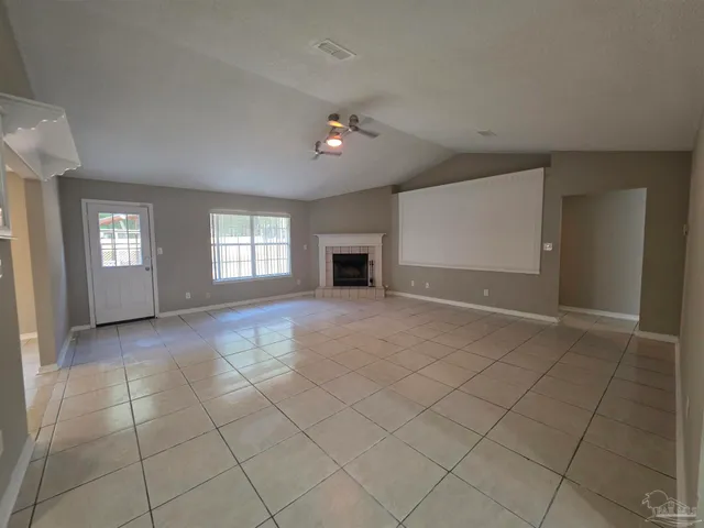 a view of empty room with window and fireplace