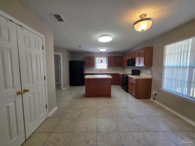 a kitchen with a cabinets and window