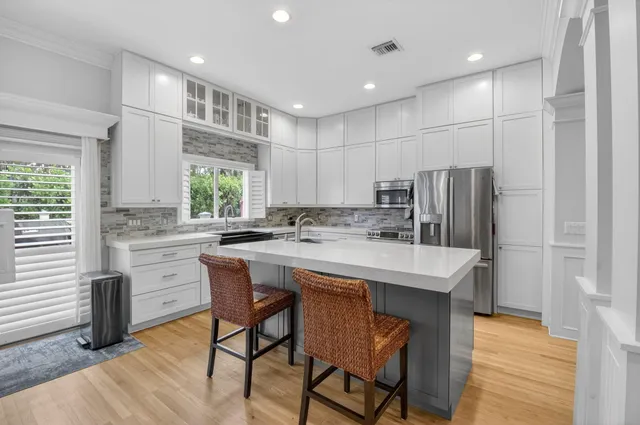 a kitchen with kitchen island a sink stove and refrigerator