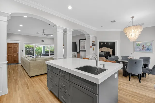 a kitchen with a table chairs and a wooden floor