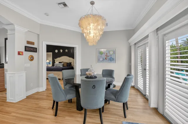 a view of a dining room with furniture wooden floor and chandelier