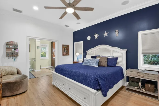a spacious bedroom with a large bed and a chandelier