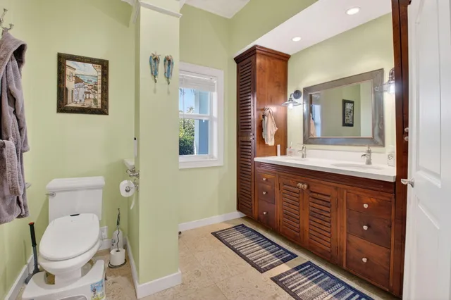 a bathroom with a toilet a sink and mirror
