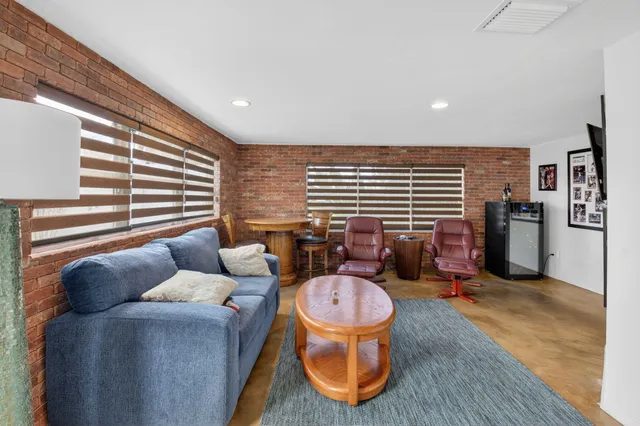 a living room with furniture a window and bookshelf