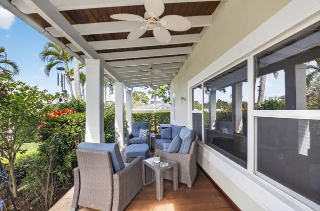 a view of a patio with a dining table and chairs